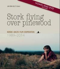 Stork flying over pinewood